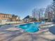 Sparkling pool with slide, alongside a fenced area near the home and additional detached structure at 810 Lake Wright Rd, China Grove, NC 28023