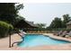 Inviting outdoor pool area with lounge chairs and a covered patio at 810 Lake Wright Rd, China Grove, NC 28023