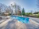 Inviting pool area featuring comfortable lounge chairs, manicured landscaping, and fenced yard at 810 Lake Wright Rd, China Grove, NC 28023