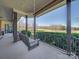 Relaxing porch with a hanging swing overlooking a grassy backyard at 810 Lake Wright Rd, China Grove, NC 28023