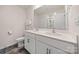 Bright bathroom features a double sink vanity with white cabinets and stone countertops at 9706 Tea Garden Dr, Gastonia, NC 28056