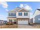 Charming two-story home featuring stone accents, a two-car garage, and a well-manicured front lawn at 9706 Tea Garden Dr, Gastonia, NC 28056