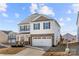 Inviting two-story home with stone details, two-car garage, and a lush front yard, perfect for families at 9706 Tea Garden Dr, Gastonia, NC 28056