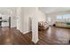 Hallway featuring wood floors leading to the living room and front entrance at 9706 Tea Garden Dr, Gastonia, NC 28056