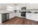 Well-lit kitchen with stainless steel appliances, granite counters, and white cabinets, great for cooking at 9706 Tea Garden Dr, Gastonia, NC 28056