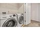 Laundry room features a modern washing machine and dryer at 9706 Tea Garden Dr, Gastonia, NC 28056