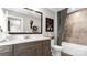 Stylish bathroom showcasing a modern vanity, decorative mirror, and shower-tub combo at 1028 Seven Sisters Ave, Monroe, NC 28110