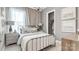 Serene bedroom featuring soft lighting, neutral tones, and a comfortable bed at 1028 Seven Sisters Ave, Monroe, NC 28110