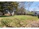 Lush backyard featuring mature trees, a utility shed and above ground pool, offering serene views at 111 Cedar Dr, Salisbury, NC 28147