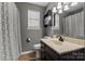 Bathroom featuring a vanity with a sink, a framed mirror, and a shower/tub combination with curtain at 111 Cedar Dr, Salisbury, NC 28147