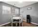 Bright dining area featuring a white round table, wood floors, and natural light from two windows at 111 Cedar Dr, Salisbury, NC 28147