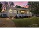 Charming single-story home with a cozy front porch, manicured lawn, and beautiful sunset backdrop at 111 Cedar Dr, Salisbury, NC 28147