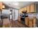 Well-equipped kitchen with stainless steel appliances, wooden cabinets, and granite countertops at 111 Cedar Dr, Salisbury, NC 28147