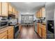 Bright kitchen featuring modern appliances, wooden cabinets, and an adjacent dining area at 111 Cedar Dr, Salisbury, NC 28147