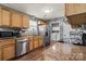 Functional kitchen with stainless steel appliances, wooden cabinets, and a granite countertop at 111 Cedar Dr, Salisbury, NC 28147