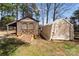 Well-maintained shed with double doors and a ramp, offering ample storage space in a backyard setting at 111 Cedar Dr, Salisbury, NC 28147