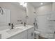 A bright bathroom featuring a double sink vanity with quartz countertops and a shower-tub combo at 113 Homewood Ln, Statesville, NC 28625