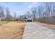 Attractive two-story home featuring a long driveway, two-car garage, and a well-maintained front yard at 113 Homewood Ln, Statesville, NC 28625