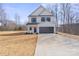 Charming two-story home with a clean white exterior and a spacious driveway leading to a two-car garage at 113 Homewood Ln, Statesville, NC 28625