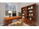 A well-lit home office featuring wood-look floors, a bookshelf, and a large window at 113 Homewood Ln, Statesville, NC 28625