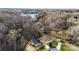 Stunning aerial view of property near the lake, featuring a manicured lawn, detached garage, and beautiful surroundings at 118 Alfara Ln, Troutman, NC 28166