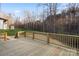 Large wooden deck with railing offers perfect outdoor entertaining space with verdant backyard at 118 Alfara Ln, Troutman, NC 28166