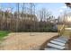 An expansive backyard featuring stepping stones leading to the deck and a wooded property line at 118 Alfara Ln, Troutman, NC 28166