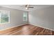 Serene bedroom with natural light, a ceiling fan, and hardwood floors, creating a peaceful retreat at 118 Alfara Ln, Troutman, NC 28166