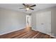 Bedroom showcasing hardwood floors, ceiling fan, and closet, illuminated by natural light at 118 Alfara Ln, Troutman, NC 28166