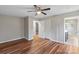 Spacious bedroom featuring hardwood floors, a ceiling fan, and an ensuite bathroom at 118 Alfara Ln, Troutman, NC 28166
