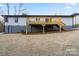 View of house's exterior featuring a newly built, elevated wooden deck with support beams at 118 Alfara Ln, Troutman, NC 28166