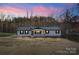 Charming home exterior with a metal roof, dark shutters, and a cozy front porch at 118 Alfara Ln, Troutman, NC 28166