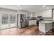 Bright kitchen featuring stainless steel appliances, white cabinets, granite countertops, and access to the deck at 118 Alfara Ln, Troutman, NC 28166