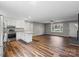 Stylish kitchen open to the living room, featuring stainless steel appliances, granite countertops, and hardwood floors at 118 Alfara Ln, Troutman, NC 28166