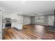 Open-concept living room with hardwood floors, recessed lighting, fireplace, and seamlessly connected to the kitchen at 118 Alfara Ln, Troutman, NC 28166
