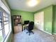 Bright, green home office with gray carpet, large window, bookshelf, and desk with desktop computer at 12217 Greymore Ct, Charlotte, NC 28277