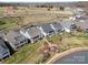 Aerial view of new home community with manicured lawns and waterfront firepit at 126 Sisters Cove Ct, Mooresville, NC 28117