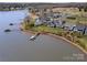 An aerial view showcasing lakefront homes along a scenic shoreline with boat docks at 126 Sisters Cove Ct, Mooresville, NC 28117