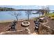 Backyard with a fire pit area, stone walls, and chairs, perfect for outdoor relaxation with a waterfront view at 126 Sisters Cove Ct, Mooresville, NC 28117