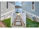 Landscaped backyard with a walkway leading to the lake offers serene views and peaceful access to the water at 126 Sisters Cove Ct, Mooresville, NC 28117