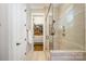 Modern bathroom with a glass-enclosed shower, walk-in closet and white towel at 126 Sisters Cove Ct, Mooresville, NC 28117