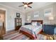 Cozy bedroom with hardwood floors, two windows, and complementary furniture at 126 Sisters Cove Ct, Mooresville, NC 28117