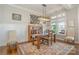 A sunny dining room with a wooden table and a decorative rug on hardwood floors at 126 Sisters Cove Ct, Mooresville, NC 28117