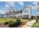 Charming blue home with a screened-in porch, manicured lawn, and inviting curb appeal at 126 Sisters Cove Ct, Mooresville, NC 28117