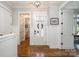 A bright foyer with wainscoting detail and an adjacent powder room at 126 Sisters Cove Ct, Mooresville, NC 28117