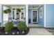 Charming front porch with rocking chairs, hanging ferns, and a beautifully decorated entrance at 126 Sisters Cove Ct, Mooresville, NC 28117