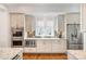 A bright kitchen with stainless appliances, ample counter space, and white cabinets at 126 Sisters Cove Ct, Mooresville, NC 28117