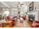 A bright living room features a fireplace, hardwood floors, and lots of natural light at 126 Sisters Cove Ct, Mooresville, NC 28117