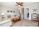 Inviting living room featuring neutral walls, carpeted floors, stylish furnishings, and a decorative ceiling fan at 126 Sisters Cove Ct, Mooresville, NC 28117