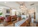 A bright, open living room with fireplace flows into the kitchen and dining room at 126 Sisters Cove Ct, Mooresville, NC 28117